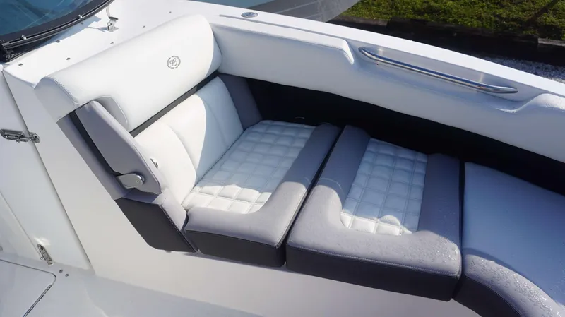 Slide: The Image of 2024 Cobalt 30 SC boat interior with white and gray cushioned seating. - 7