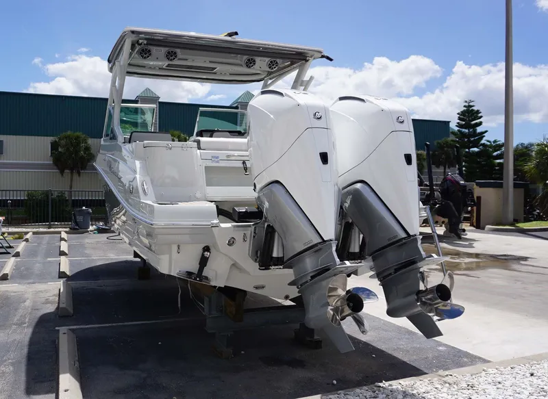Slide: The Image of 2024 Crownline 280 DC boat with dual outboard engines. - 12