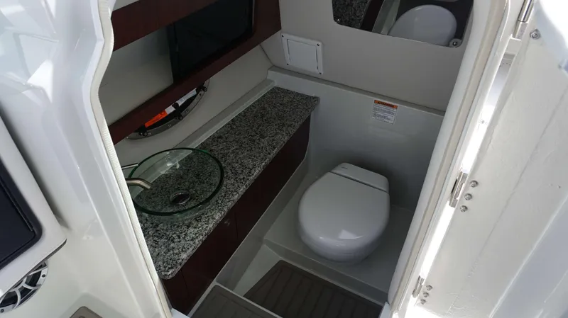 Slide: The Image of 2024 Crownline 280 DC boat bathroom with granite countertop and modern fixtures. - 14