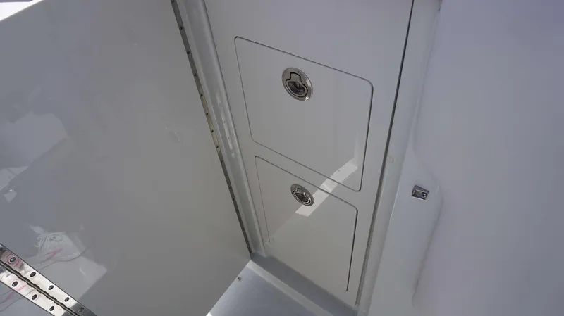 Slide: The Image of Storage compartments on the 2024 Crownline 280 DC boat. - 16