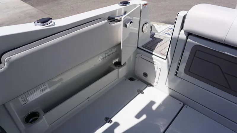 Slide: The Image of Interior view of 2024 Crownline 280 DC boat, showcasing seating and storage compartments. - 19