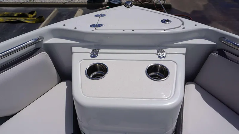 Slide: The Image of Crownline 280 DC 2024 boat interior with cup holders and seating area. - 28