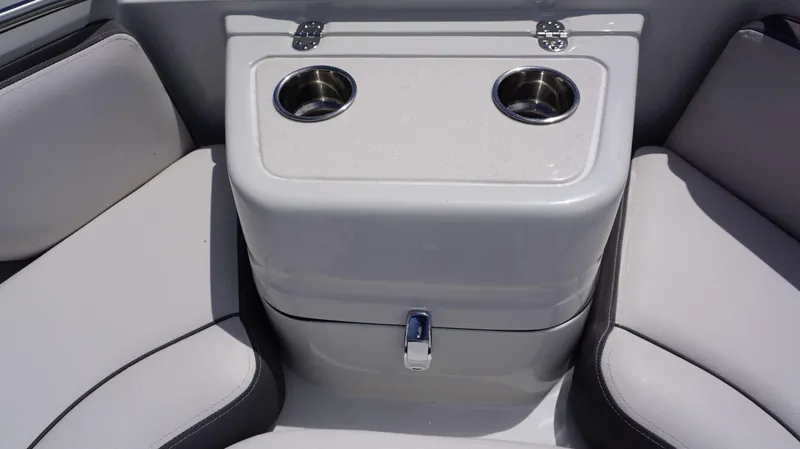 Slide: The Image of Crownline 280 DC 2024 boat interior with dual cup holders and cushioned seating. - 29