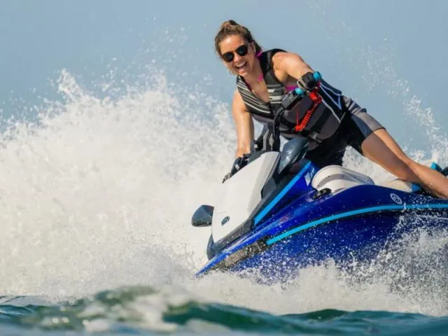 Slide: The Image of Woman riding 2024 Yamaha Waverunners JetBlaster® on the water, creating splashes. - 4