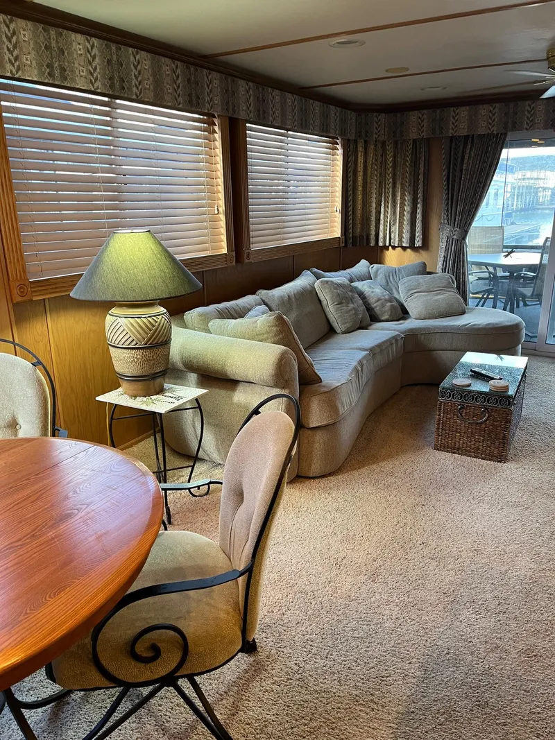 Slide: The Image of Interior of a 2003 Lakeview Houseboat with cozy seating and dining area. - 10