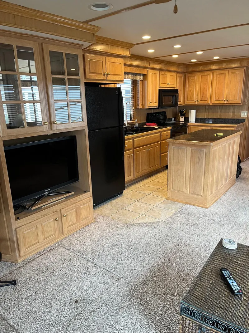 Slide: The Image of Interior of a 2003 Lakeview Houseboat with kitchen and living area. - 11