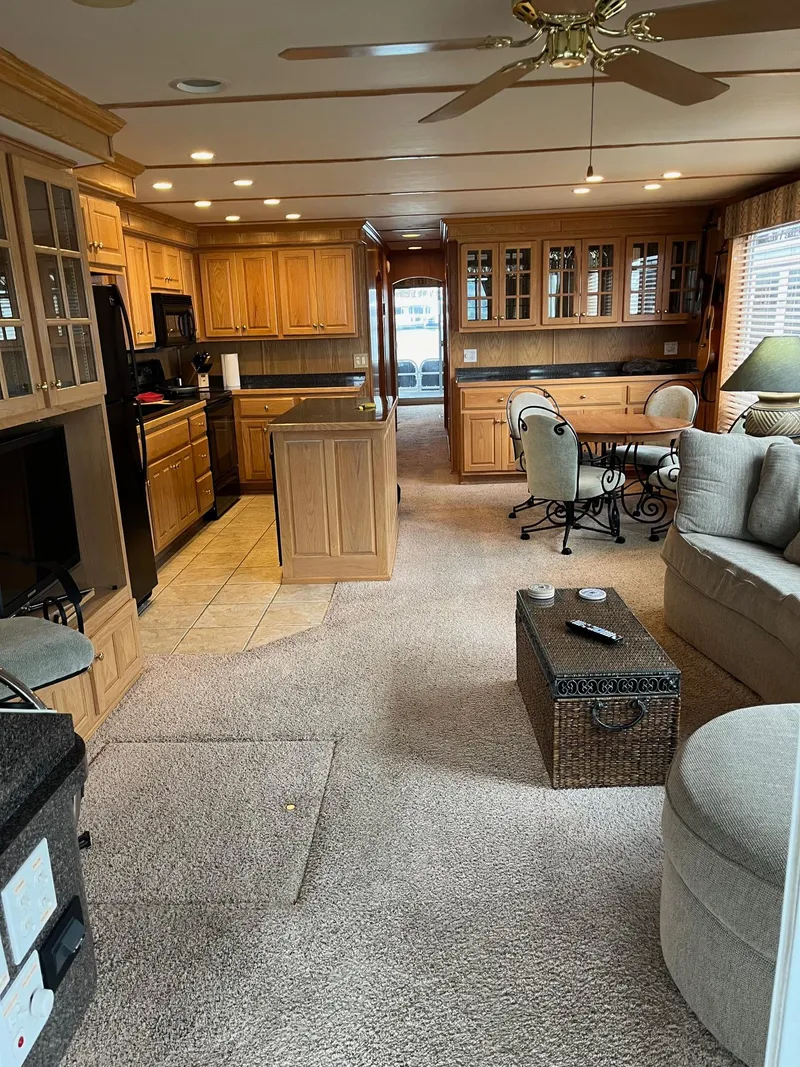 Slide: The Image of Spacious 2003 Lakeview houseboat interior with kitchen, dining area, and cozy living space. - 14