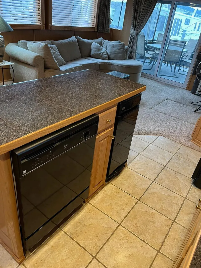Slide: The Image of 2003 Lakeview Houseboat interior with kitchen island and cozy living area. - 15
