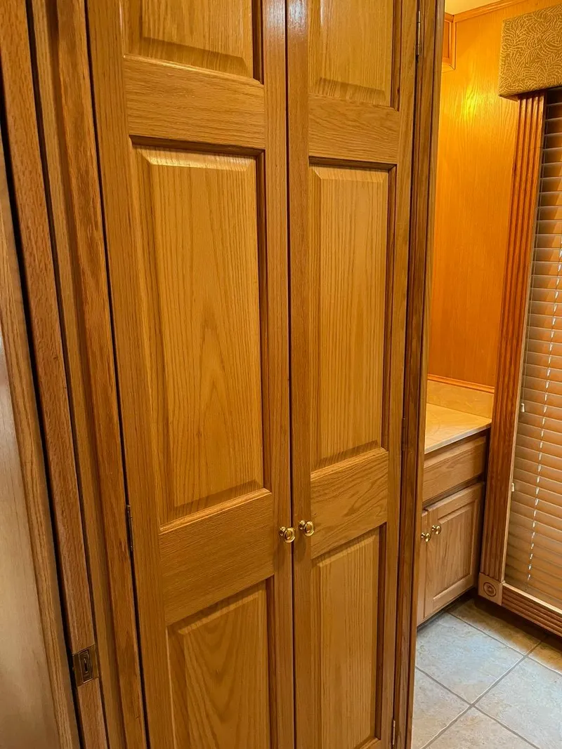 Slide: The Image of Wooden closet doors inside a 2003 Lakeview Houseboat. - 19