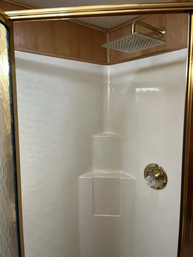 Slide: The Image of 2003 Lakeview Houseboat shower with gold fixtures and white interior - 22