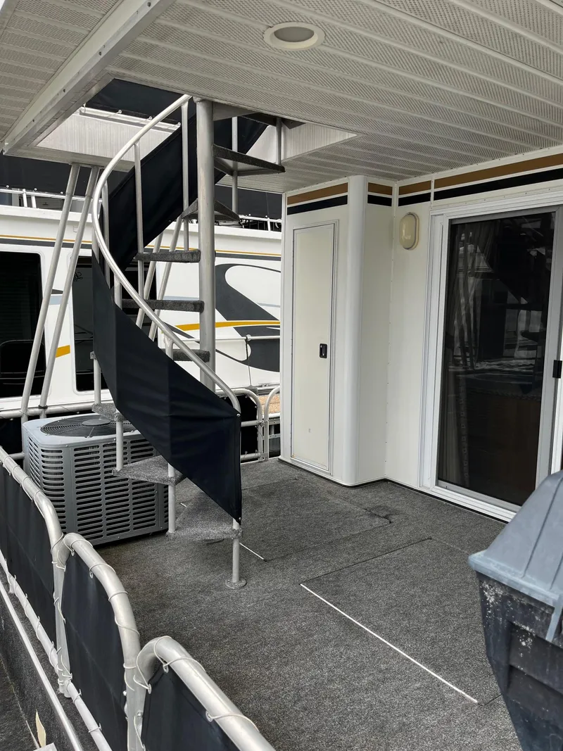 Slide: The Image of 2003 Lakeview Houseboat with spiral staircase and outdoor deck. - 25
