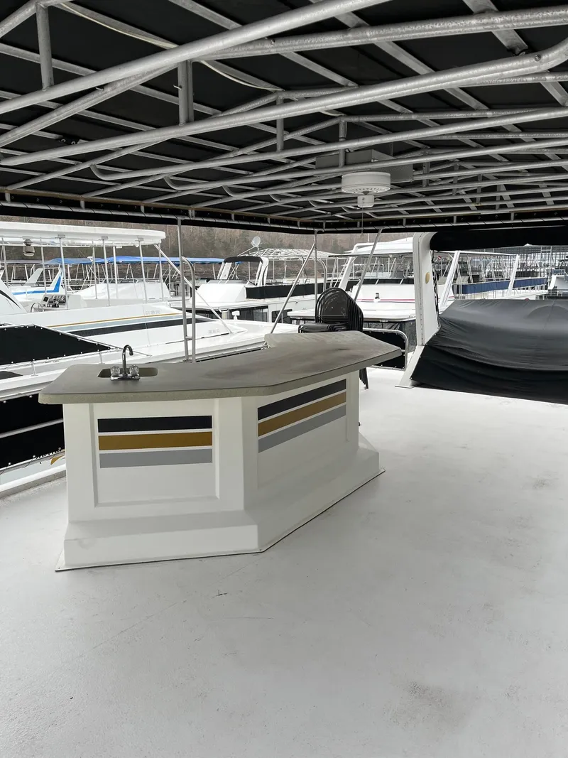 Slide: The Image of 2003 Lakeview Houseboat with covered deck and outdoor bar area. - 26