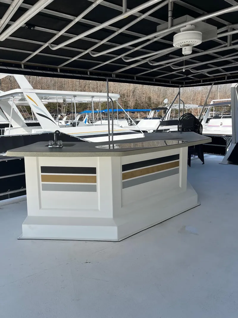 Slide: The Image of 2003 Lakeview Houseboat with outdoor bar and seating area. - 28