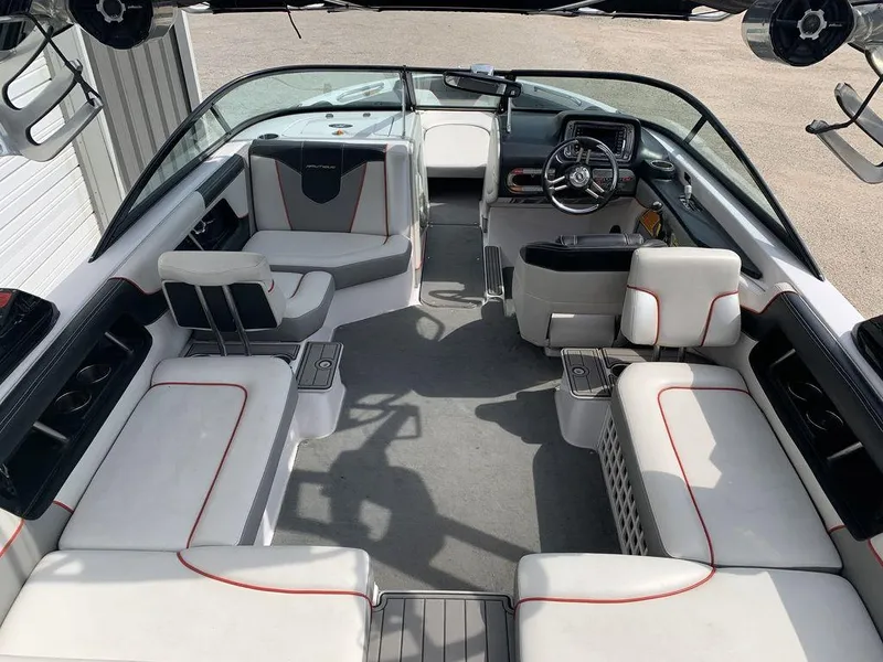 Slide: The Image of Interior of a 2012 Nautique 230 boat with white and gray seating. - 2