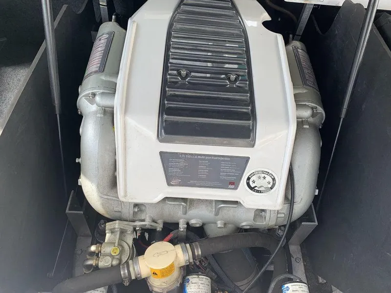 Slide: The Image of 2012 Nautique 230 boat engine compartment with 5.7L V8 multi-port fuel injection system. - 5
