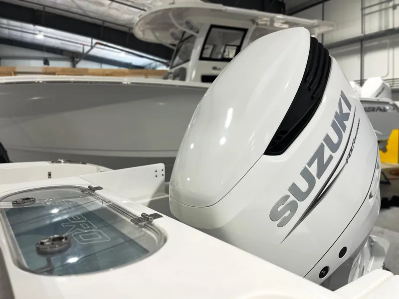 Slide: The Image of 2024 Sea Pro 242 DLX boat with Suzuki outboard motor in showroom. - 3