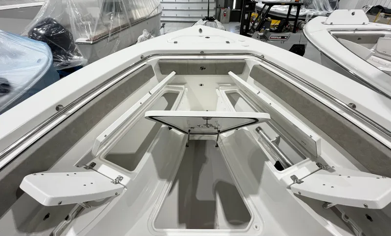 Slide: The Image of 2024 Sea Pro 242 DLX boat interior with open storage compartments. - 12