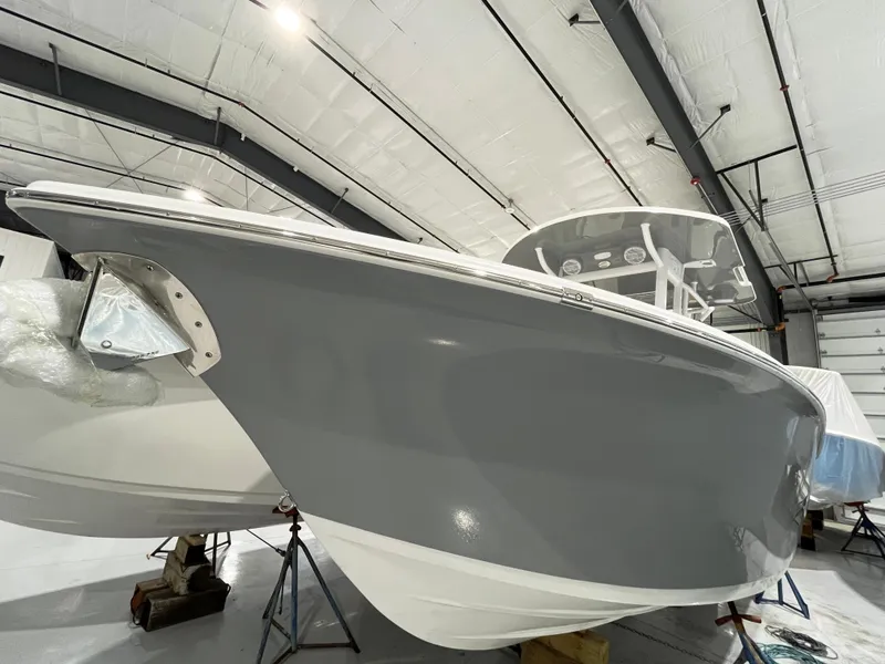 Slide: The Image of 2024 Sea Pro 242 DLX boat in a storage facility. - 15