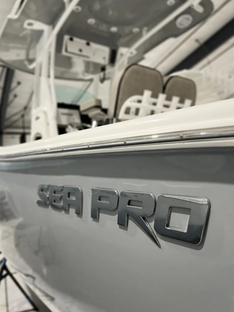 Slide: The Image of 2024 Sea Pro 242 DLX boat interior and branding. - 16