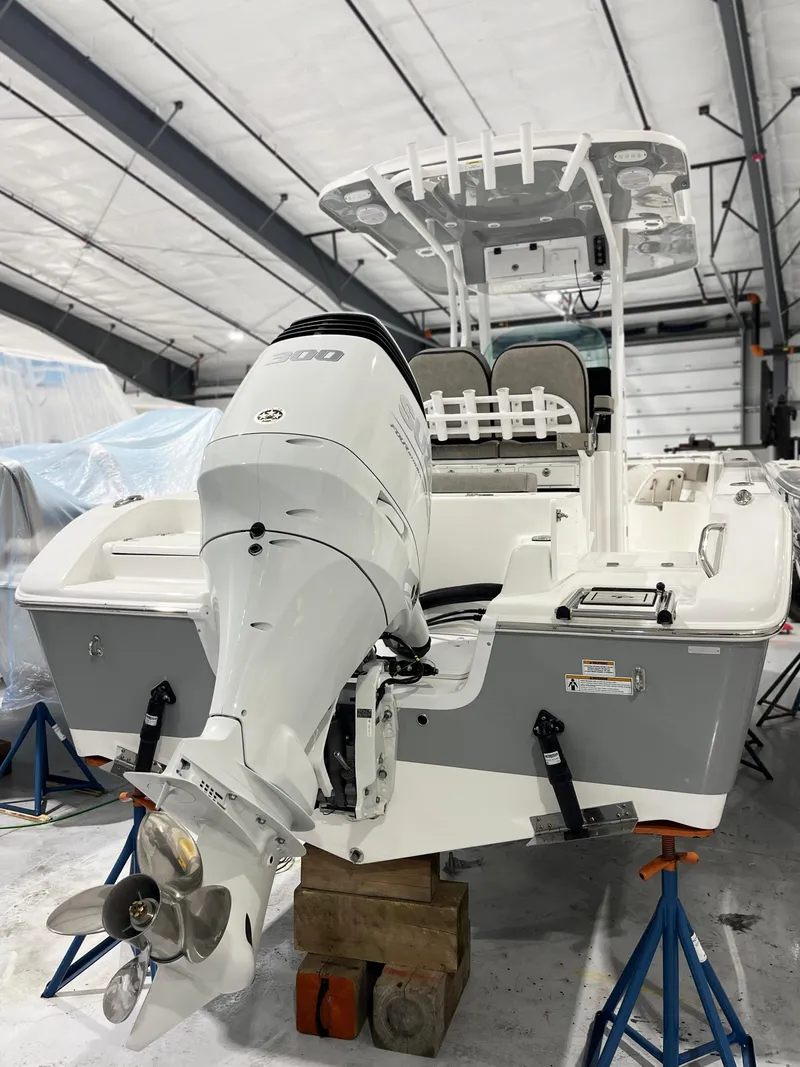 Slide: The Image of 2024 Sea Pro 242 DLX boat in a storage facility. - 18