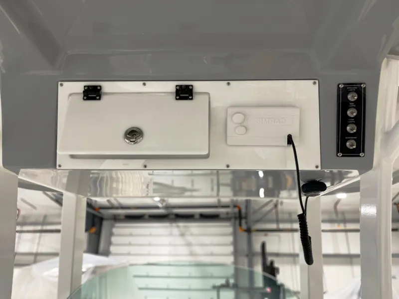 Slide: The Image of 2024 Sea Pro 242 DLX boat console with storage compartment and control panel. - 2