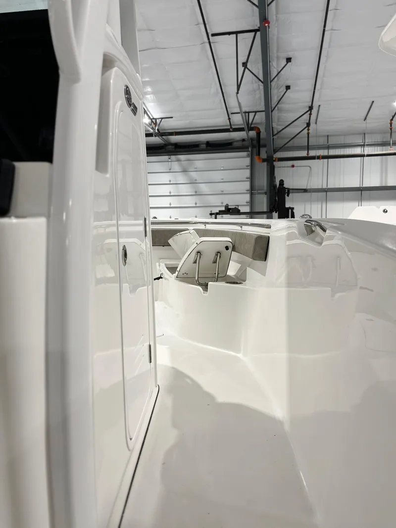 Slide: The Image of 2024 Sea Pro 242 DLX boat interior in a warehouse. - 6