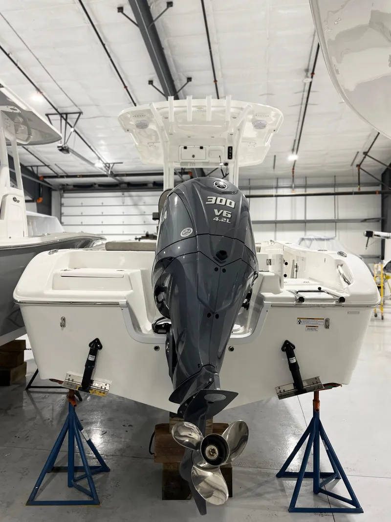 Slide: The Image of 2024 Sea Pro 242 DLX boat with 300 V6 engine in a showroom. - 10