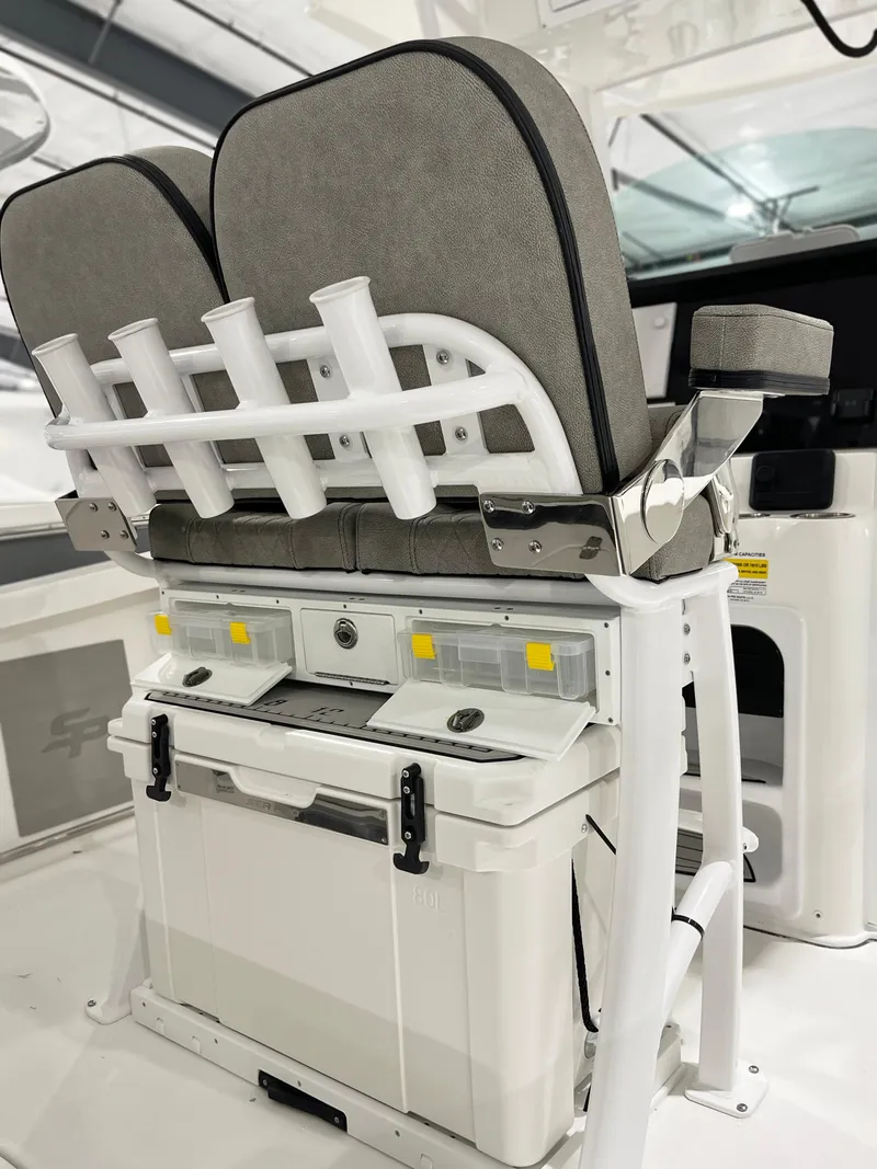 Slide: The Image of 2024 Sea Pro 242 DLX boat seating and storage area with rod holders. - 4