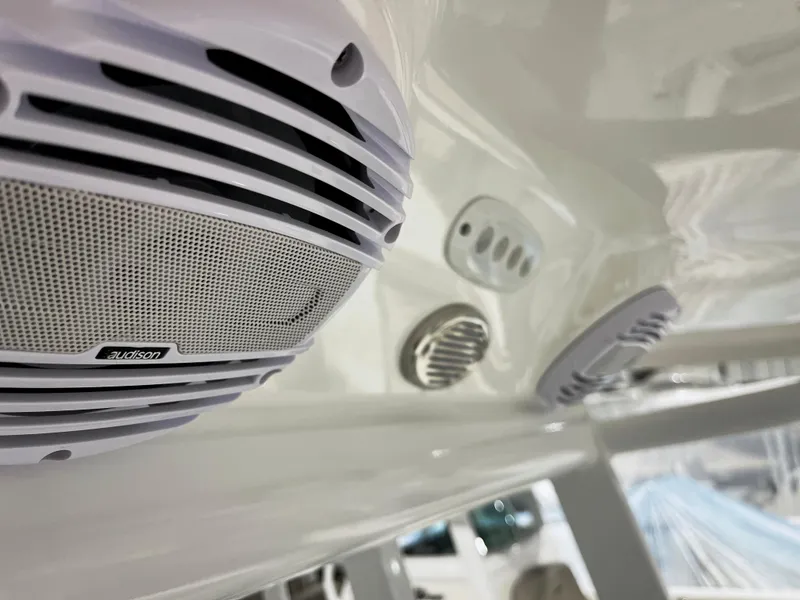 Slide: The Image of Close-up of 2024 Sea Pro 242 DLX boat's audio system and ventilation. - 8
