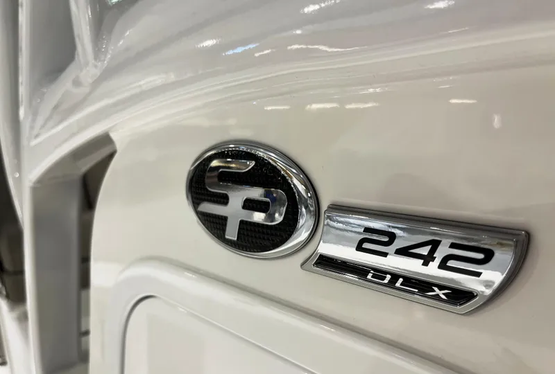 Slide: The Image of 2024 Sea Pro 242 DLX boat emblem and model badge. - 9