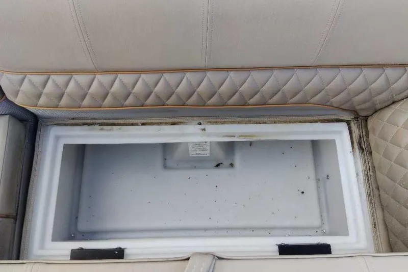 Slide: The Image of 2024 Ranger Reata 220C boat seat storage compartment, open with quilted upholstery. - 59