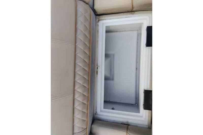 Slide: The Image of Open storage compartment in 2024 Ranger Reata 220C boat with quilted upholstery. - 60
