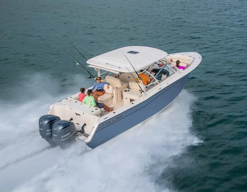 Slide: The Image of 2024 Grady-White 307 boat cruising on water with passengers. - 1