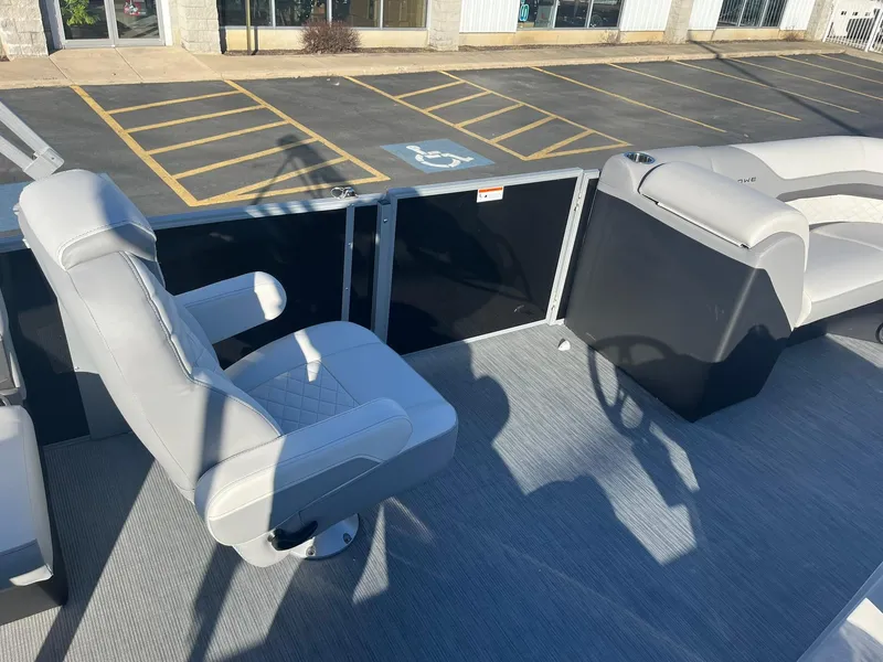 Slide: The Image of 2024 Lowe SS 210 WT boat interior with captain's chair and steering console. - 11