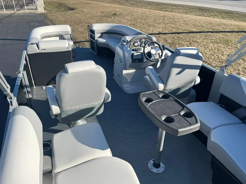 Slide: The Image of 2024 Lowe SS 210 WT pontoon boat interior with seating and steering console. - 12