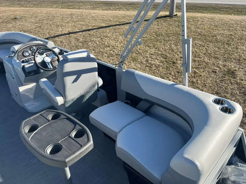 Slide: The Image of 2024 Lowe SS 210 WT boat interior with helm, seating, and cup holders. - 14
