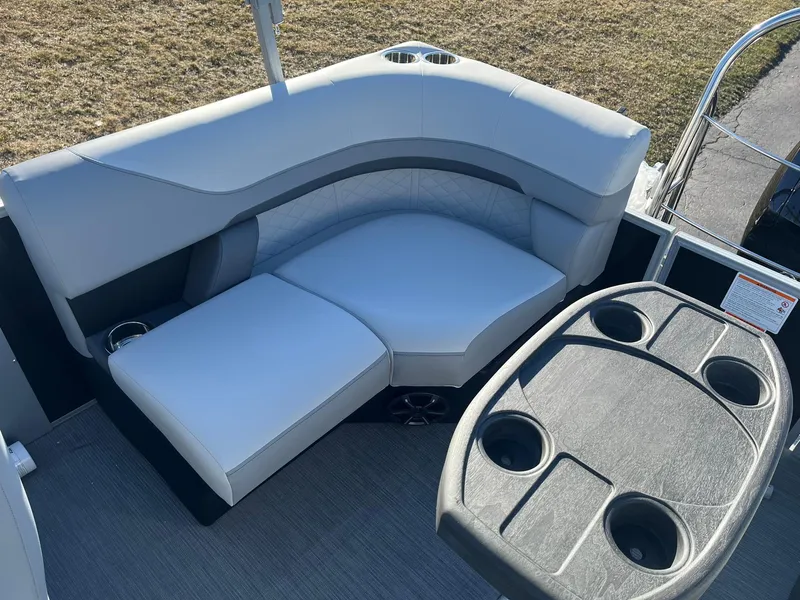 Slide: The Image of 2024 Lowe SS 210 WT boat interior with cushioned seating and cup holders. - 16