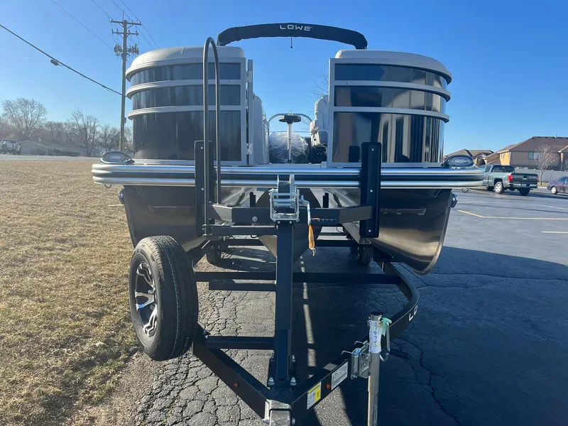 Slide: The Image of 2024 Lowe SS 210 WT pontoon boat on a trailer, front view. - 2