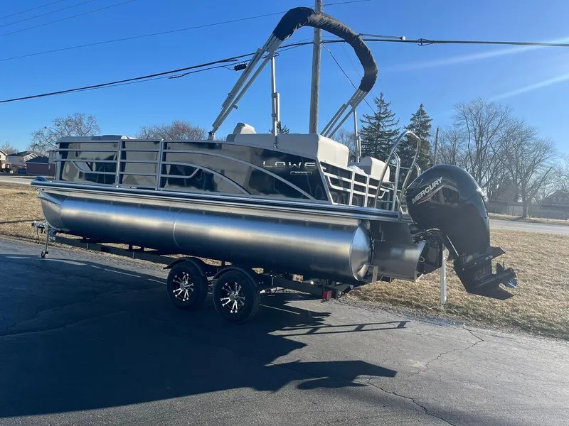 Slide: The Image of 2024 Lowe SS 210 WT pontoon boat on a trailer with Mercury outboard motor. - 21