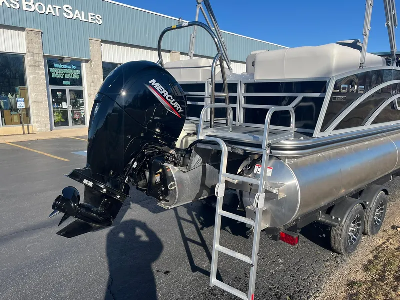 Slide: The Image of 2024 Lowe SS 210 WT pontoon boat with Mercury outboard motor at a boat sales dealership. - 3