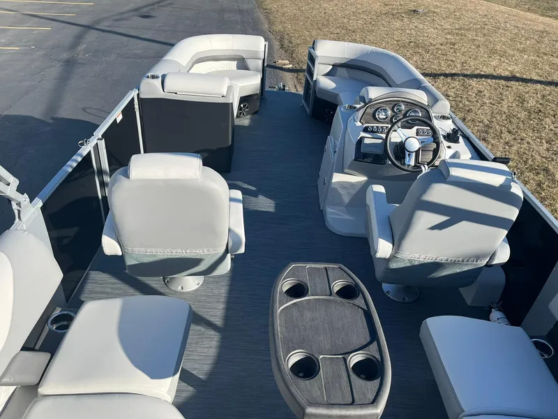Slide: The Image of 2024 Lowe SS 210 WT pontoon boat interior with seating and steering console. - 5