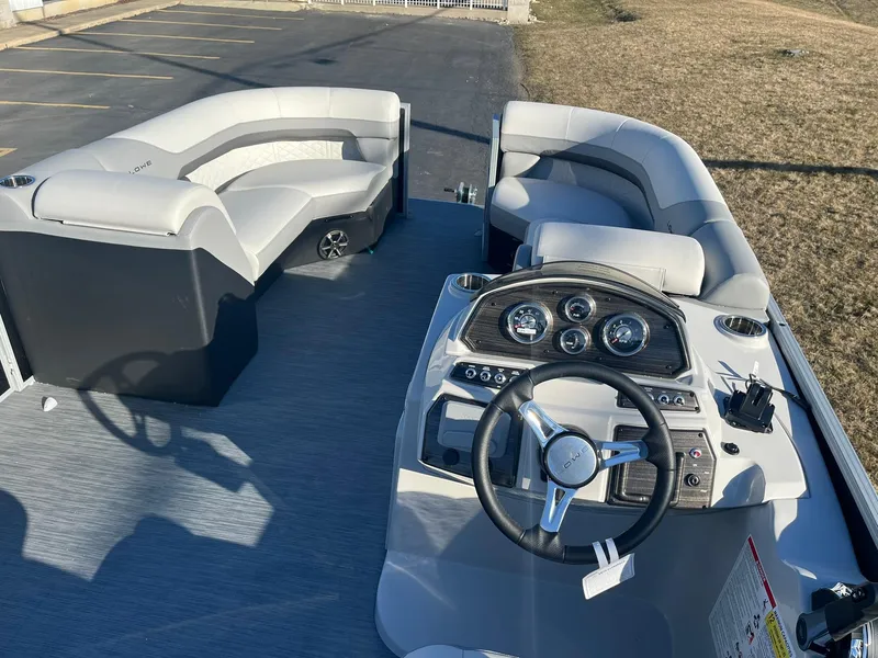 Slide: The Image of 2024 Lowe SS 210 WT pontoon boat interior with steering console and seating. - 6