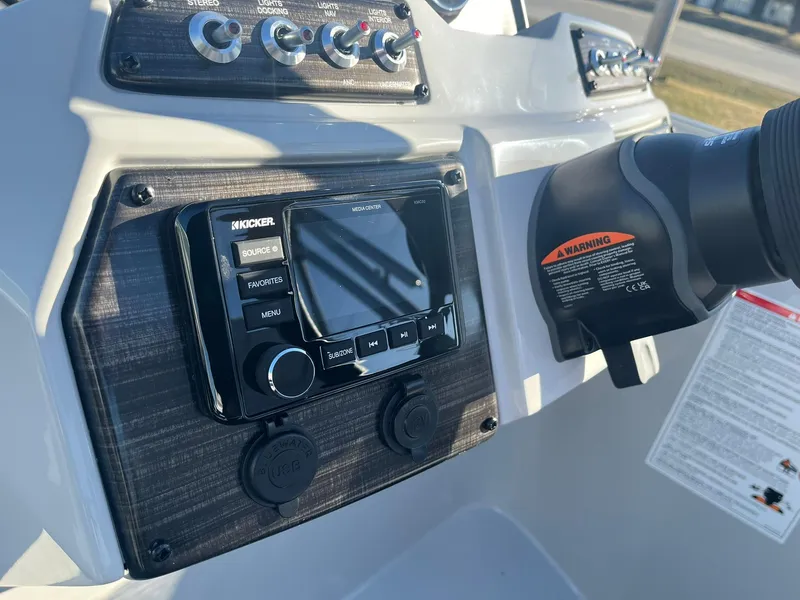 Slide: The Image of Control panel of 2024 Lowe SS 210 WT boat with Kicker audio system. - 9