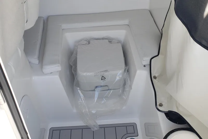 Slide: The Image of 2024 Sea Fox 248 Side Console boat interior with a covered toilet. - 16