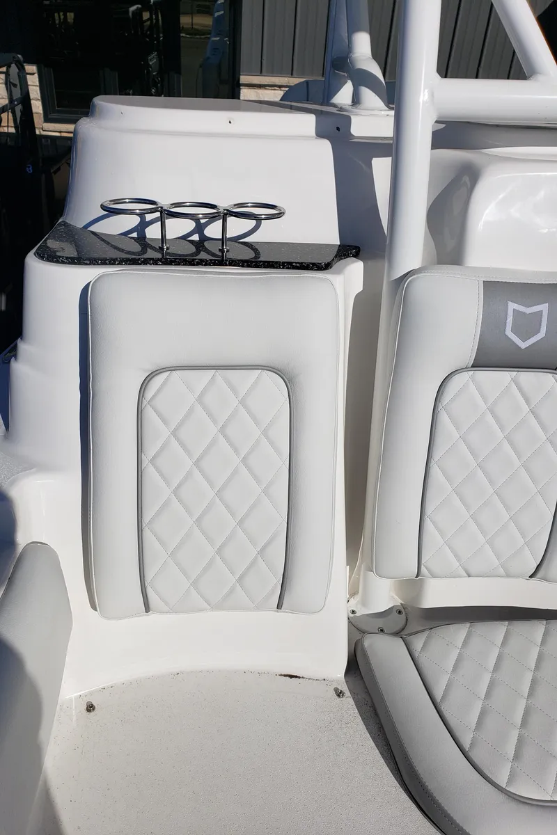 Slide: The Image of 2024 Sea Fox 248 Side Console boat interior with quilted seats and cup holders. - 22