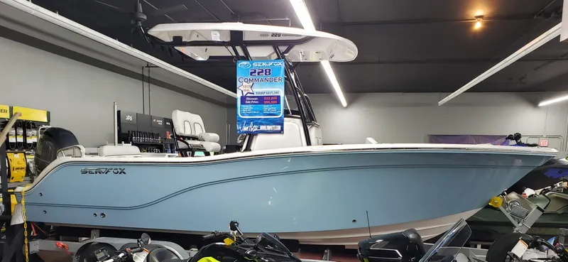 Slide: The Image of 2023 Sea Fox 228 Commander boat displayed in a showroom. - 2