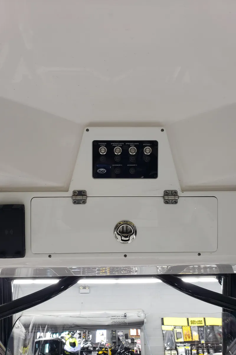 Slide: The Image of 2023 Sea Fox 228 Commander boat console with control panel and storage compartment. - 8