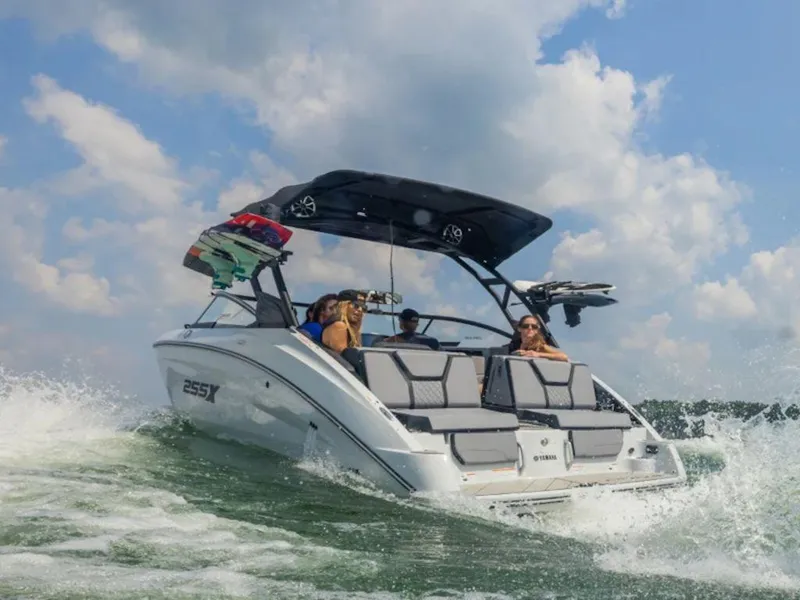 Slide: The Image of 2024 Yamaha Boats 255XD on water with passengers enjoying a sunny day. - 3