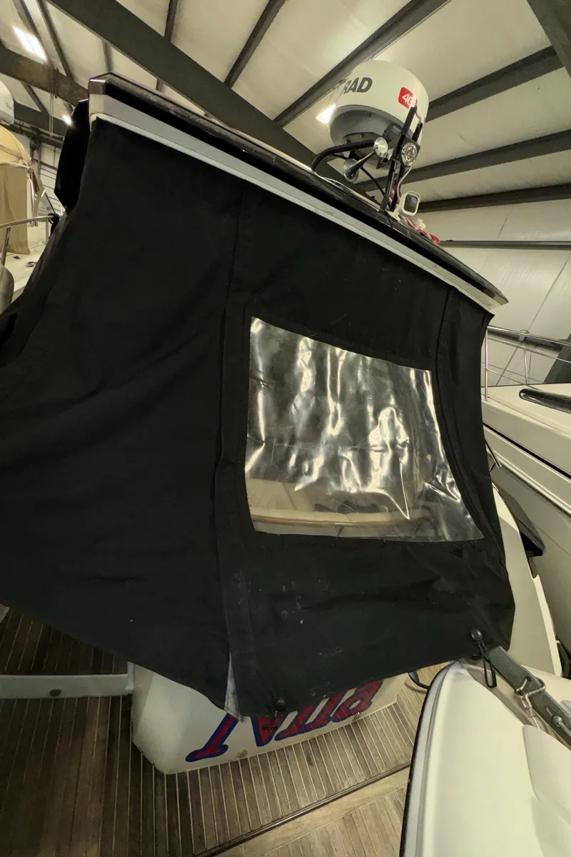 Slide: The Image of 2018 Beneteau 40 Gran Tourismo boat with black cover in storage. - 11