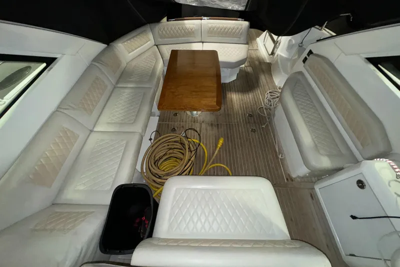 Slide: The Image of Interior of 2018 Beneteau 40 Gran Tourismo with white seating and wooden table. - 12